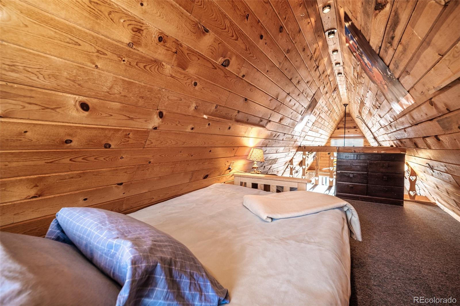 340 Wampum Lane Como, CO 80456 - Photo 18 of 35 a bedroom with a bed and a night stand