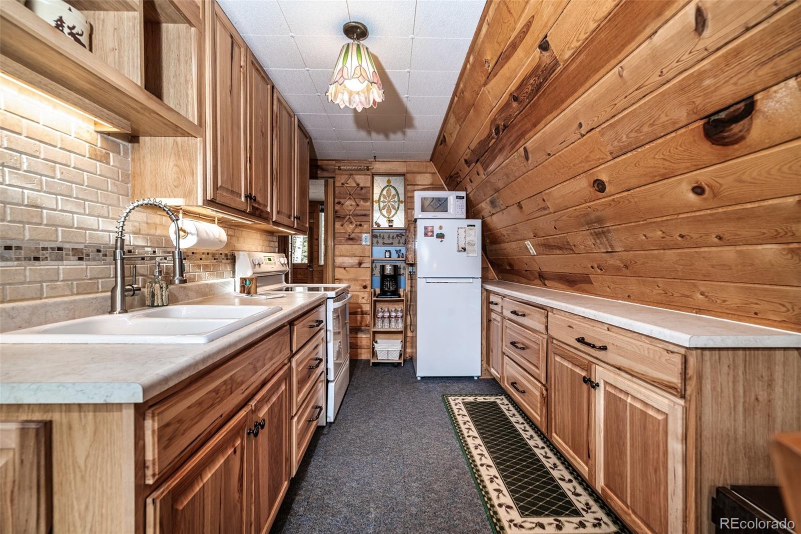 340 Wampum Lane Como, CO 80456 - Photo 3 of 35 a kitchen with cabinets and stove