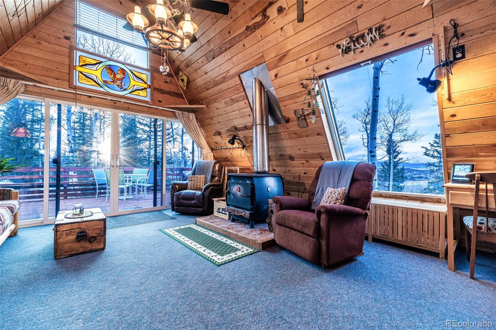 340 Wampum Lane Como, CO 80456 - Photo 6 of 35 a living room with furniture a flat screen tv and a floor to ceiling window