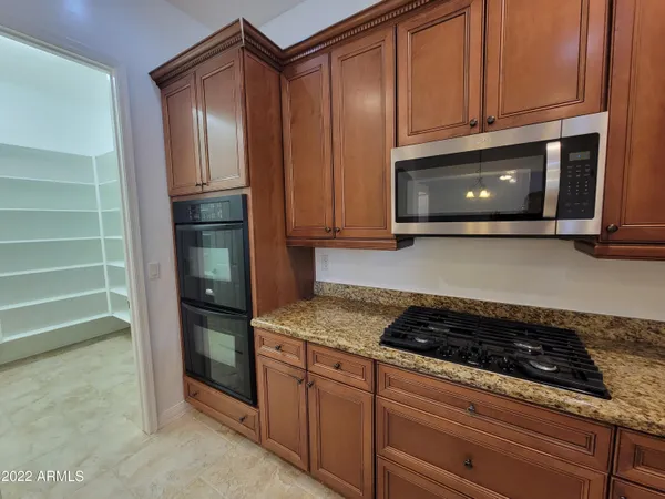 a kitchen with granite countertop cabinets and steel stainless steel appliances with cabinets