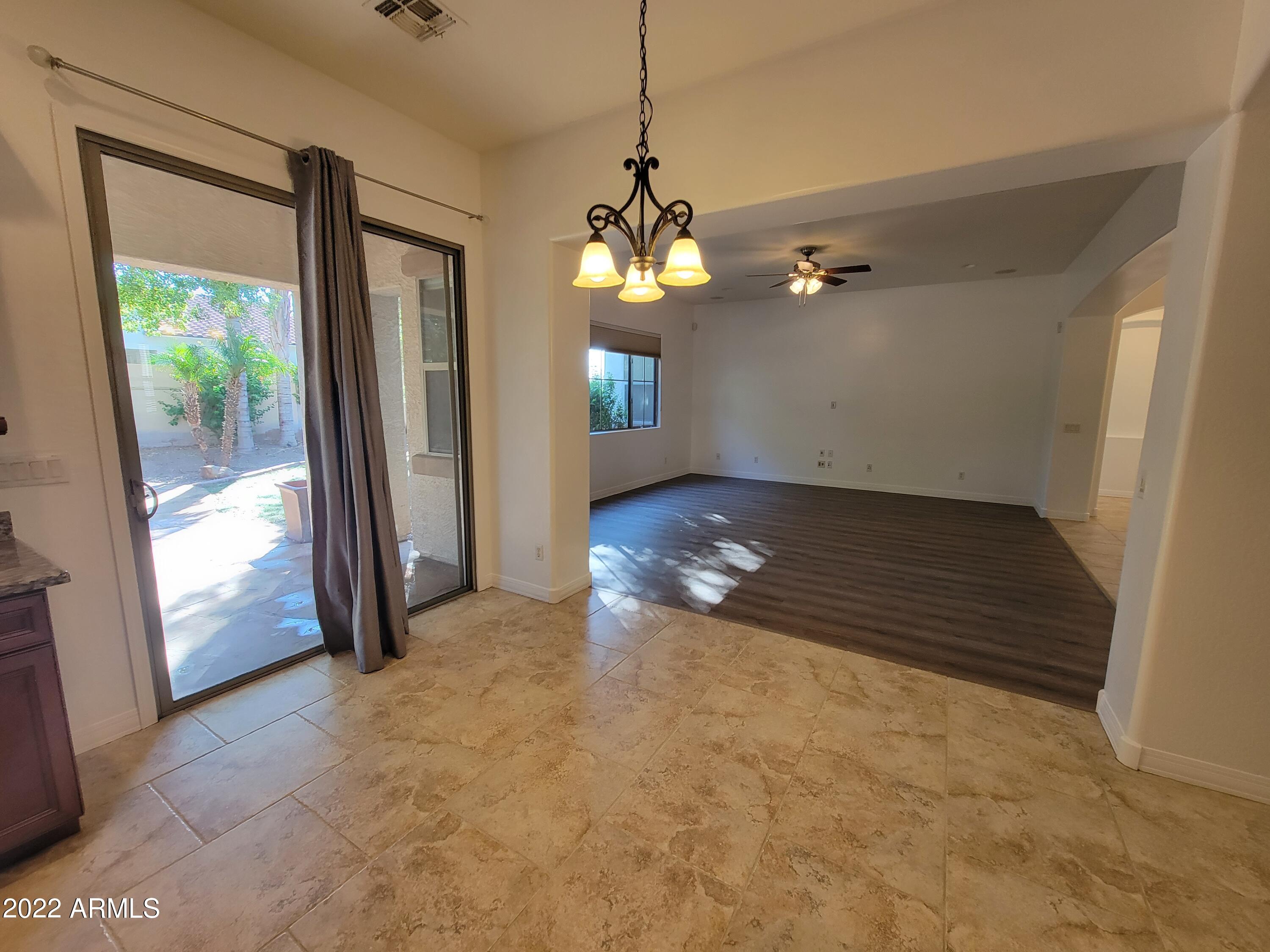 6335 South Roanoke Street Gilbert, AZ 85298 - Photo 13 of 36 a view of a room with a chandelier fan and windows