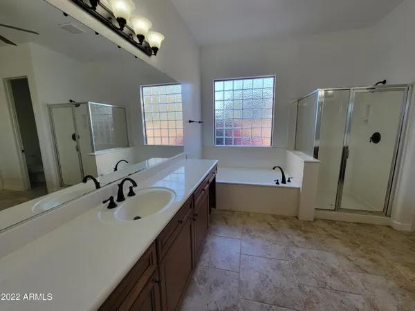 a bathroom with a tub sink and mirror