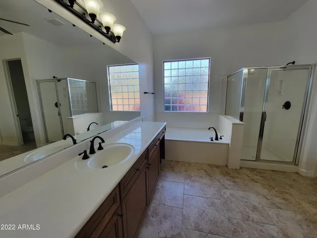 a bathroom with a tub sink and mirror