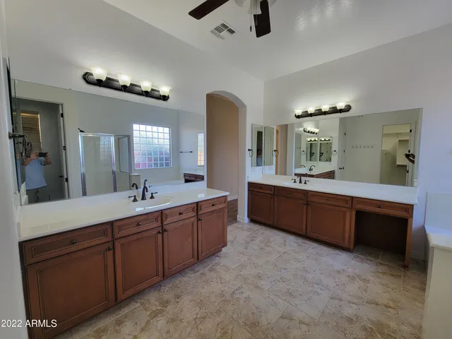 a bathroom with a double vanity sink and a mirror