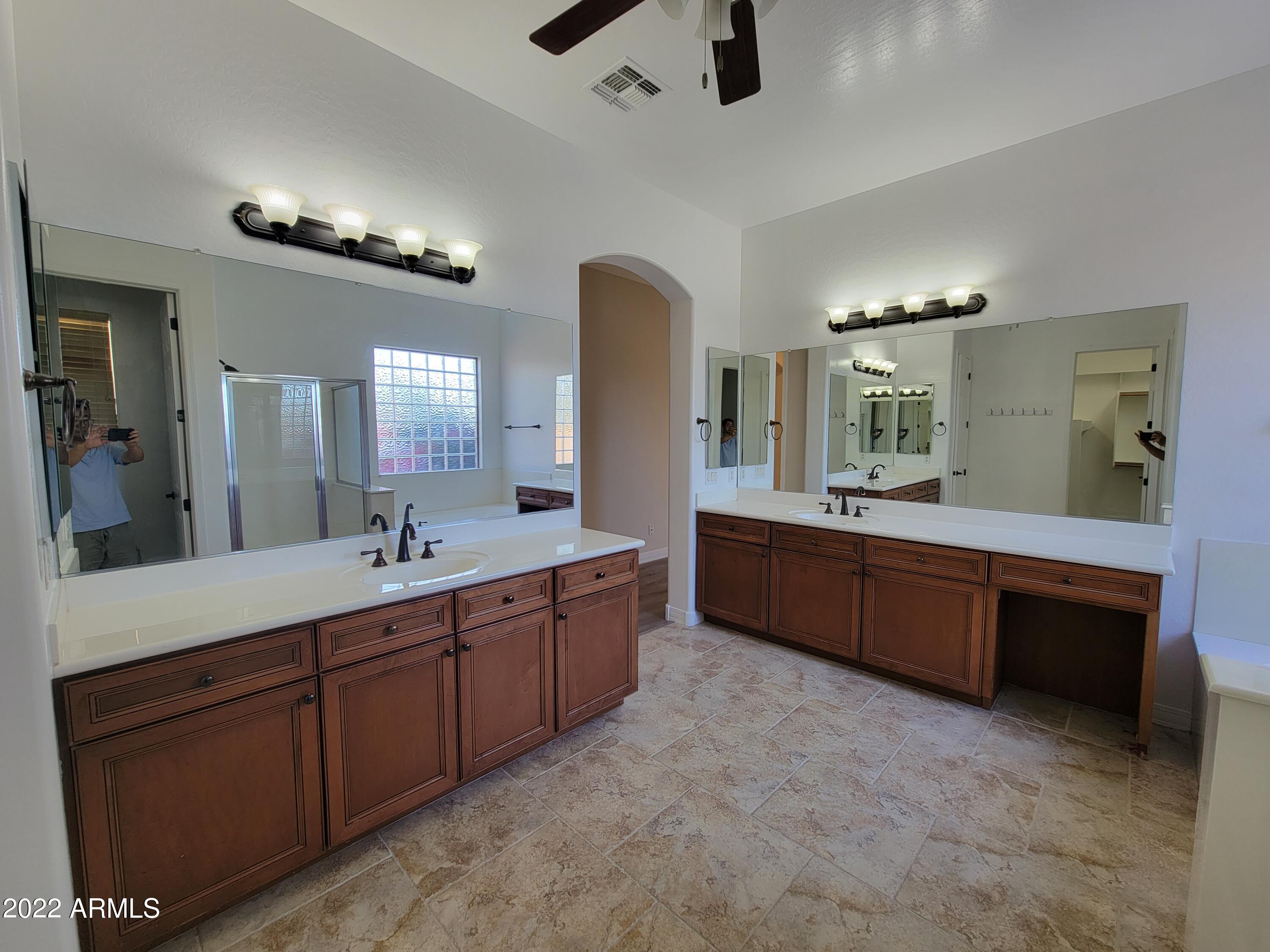 6335 South Roanoke Street Gilbert, AZ 85298 - Photo 18 of 36 a bathroom with a double vanity sink and a mirror