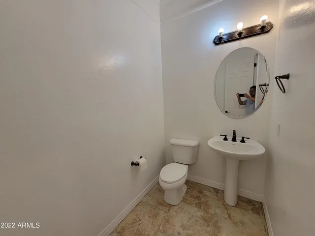 a bathroom with a sink toilet and a mirror