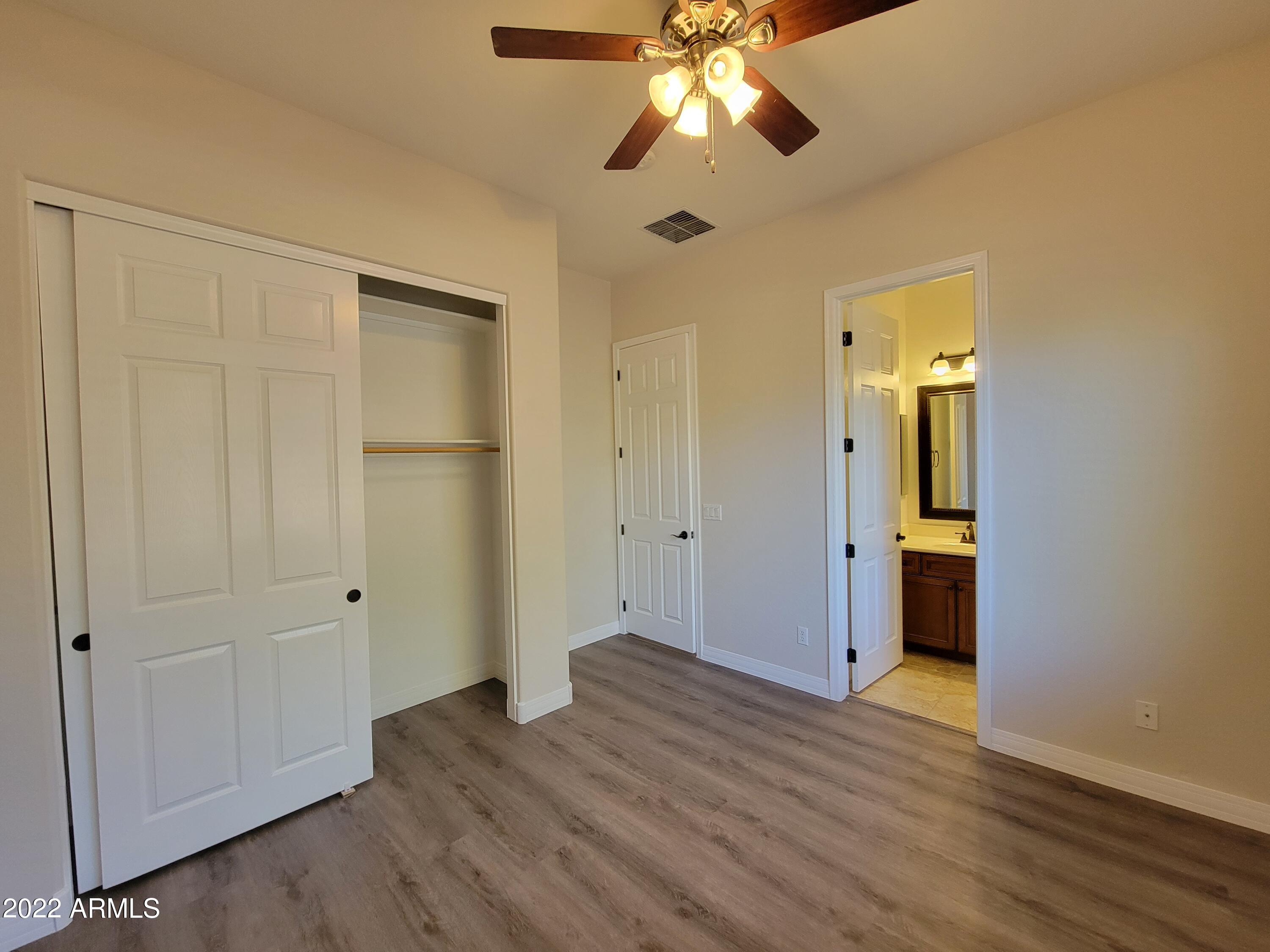 6335 South Roanoke Street Gilbert, AZ 85298 - Photo 23 of 36 a view of an empty room with wooden floor