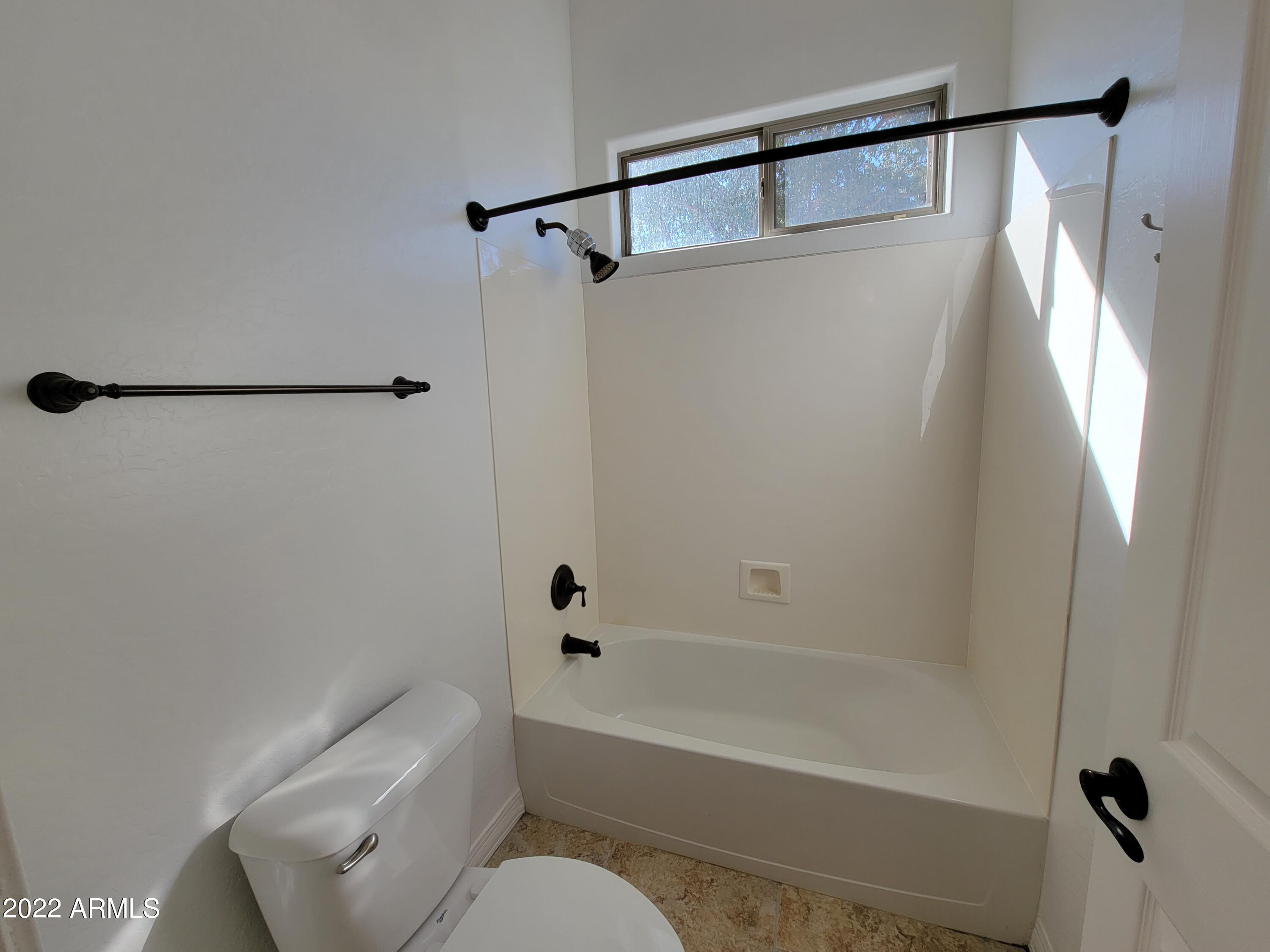 6335 South Roanoke Street Gilbert, AZ 85298 - Photo 28 of 36 a bathroom with a shower a toilet and a tub
