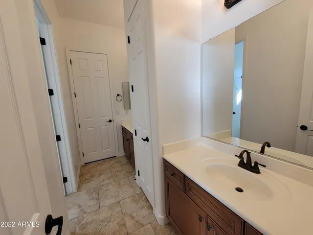 a bathroom with a sink and mirror