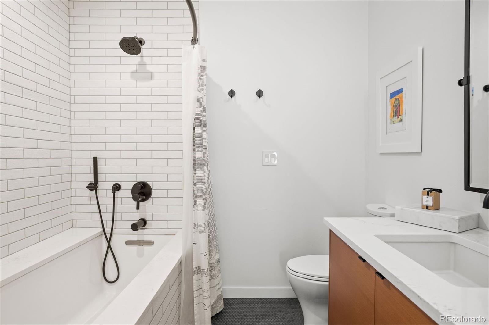 3400 Tejon Street Denver, CO 80211 - Photo 22 of 40 a bathroom with a granite countertop toilet sink and shower