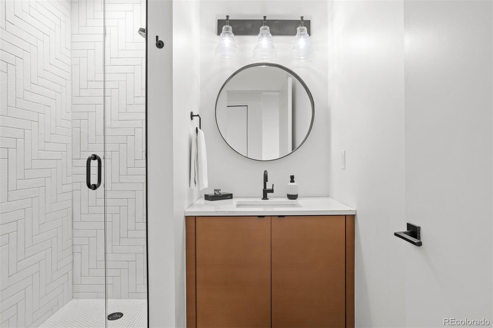 3400 Tejon Street Denver, CO 80211 - Photo 24 of 40 a bathroom with a sink and a mirror