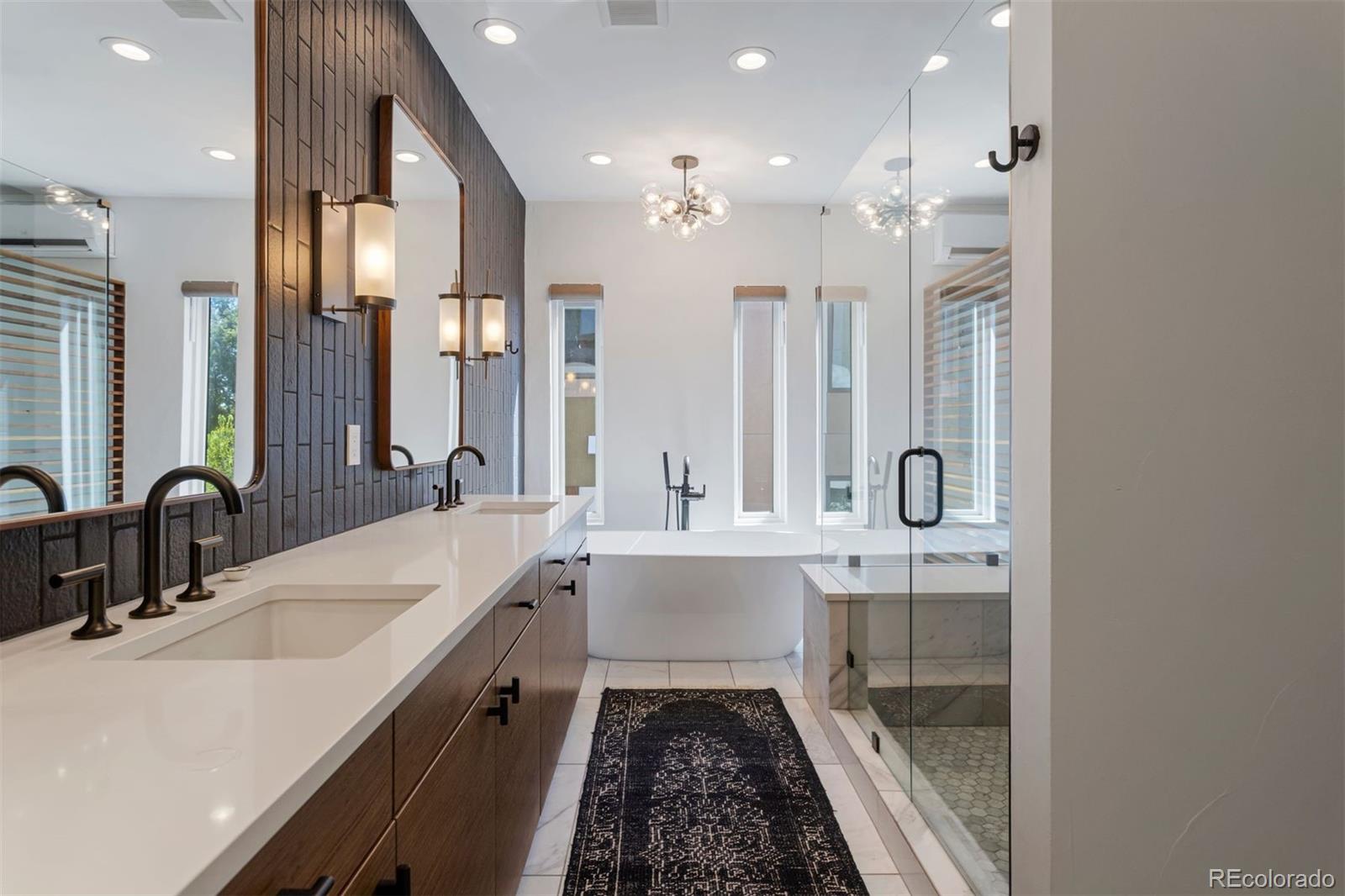 3400 Tejon Street Denver, CO 80211 - Photo 31 of 40 a bathroom with a double vanity sink a mirror and a bathtub