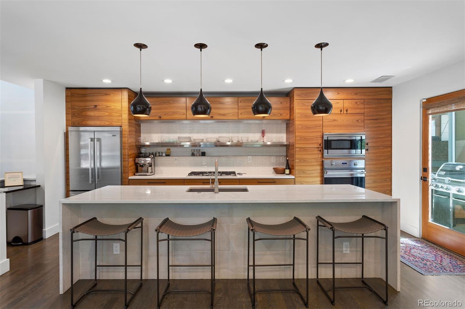 3400 Tejon Street Denver, CO 80211 - Photo 8 of 40 a kitchen with stainless steel appliances granite countertop a kitchen island a stove and a refrigerator