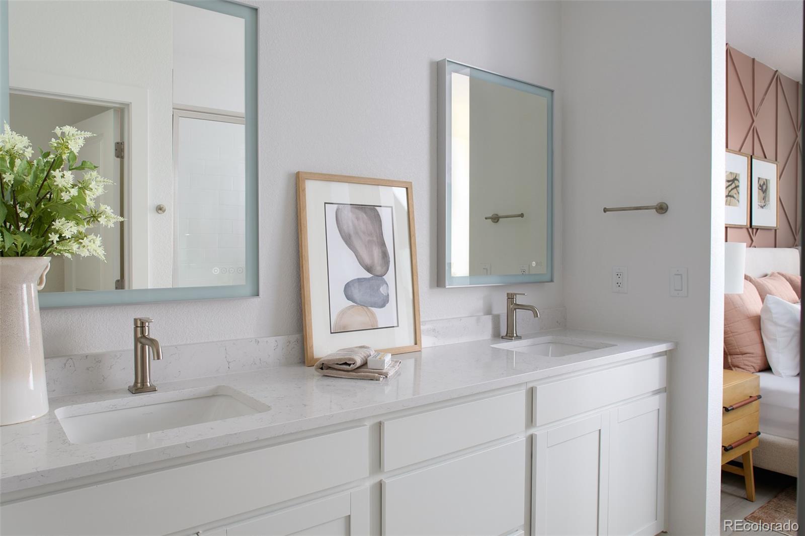 11940 Soprano Circle, Unit 204 Lone Tree, CO 80134 - Photo 3 of 11 a bathroom with a sink and a mirror