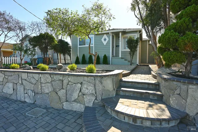a view of a patio with table and chairs potted plants and a large tree