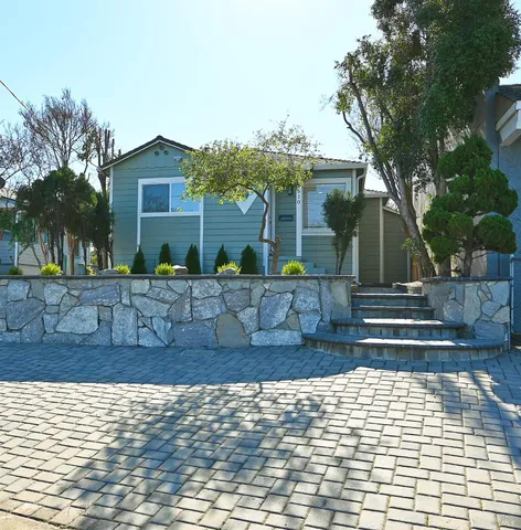 a front view of a house with garden