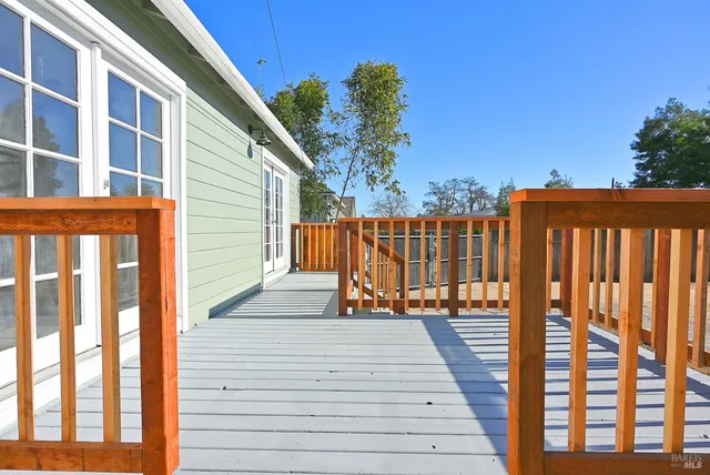 a view of balcony with wooden floor and seating space