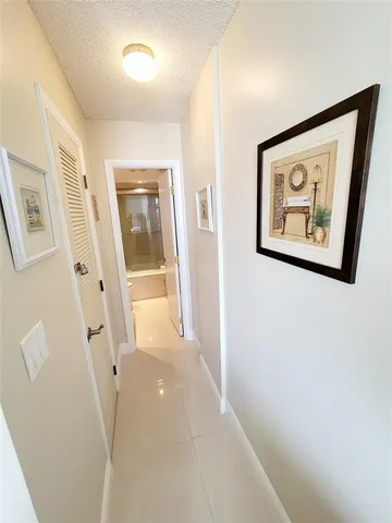 a view of a hallway with paintings on the wall