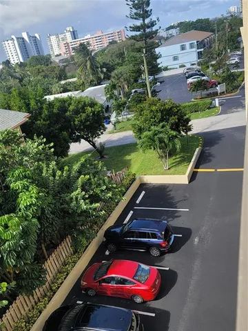 a view of a chairs and table in a balcony