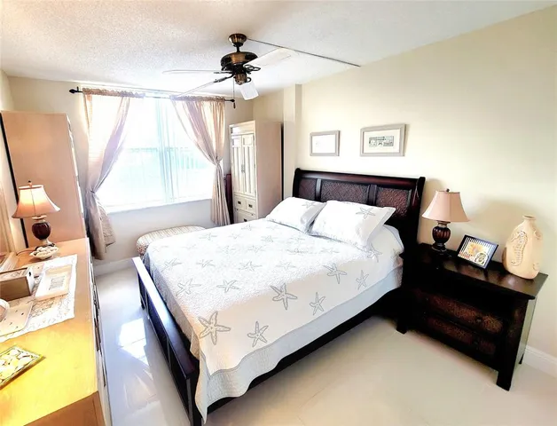 a bedroom with a bed couch and a window