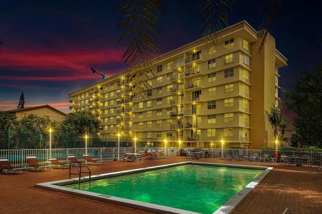 a view of a tall building with a swimming pool