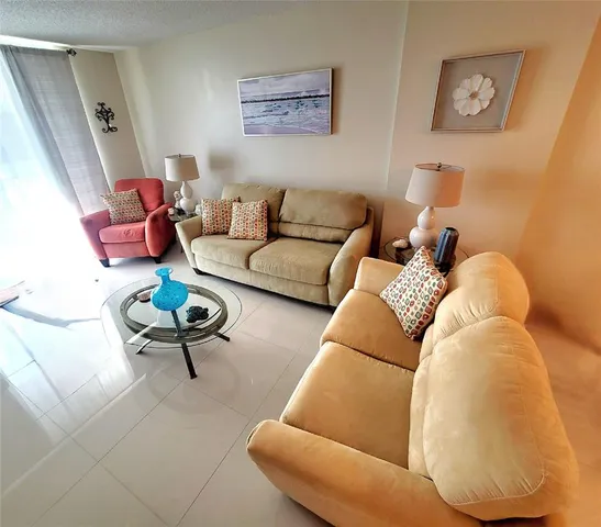 a living room with furniture and a rug