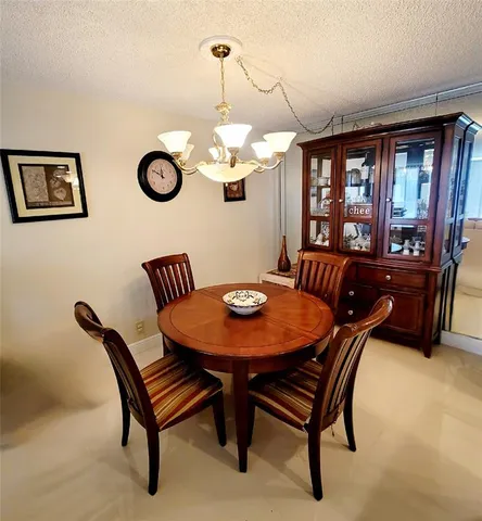 a view of a dining room with furniture and window