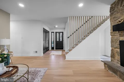 a view of entryway and hall with wooden floor