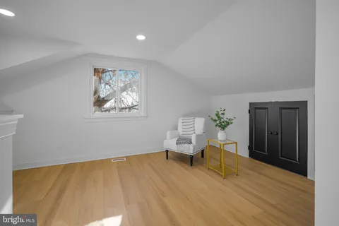 a workspace with wooden floor and furniture