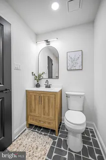 a bathroom with a toilet sink and mirror