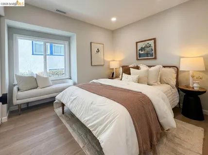 a spacious bedroom with a bed and a couch