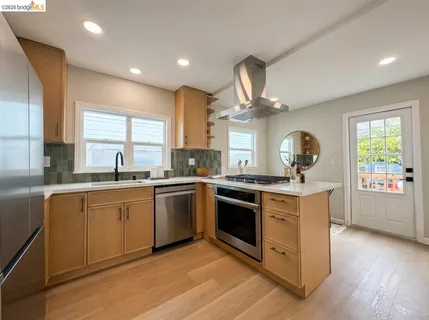 a kitchen with stainless steel appliances granite countertop a stove and a sink