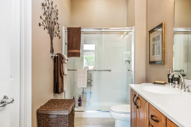 a bathroom with a granite countertop sink toilet and shower