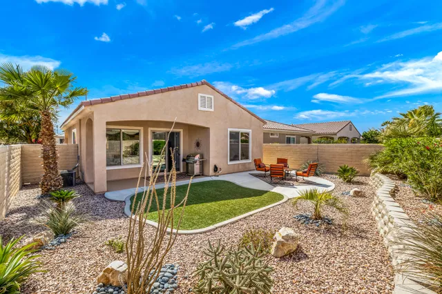 a front view of a house with swimming pool outdoor seating