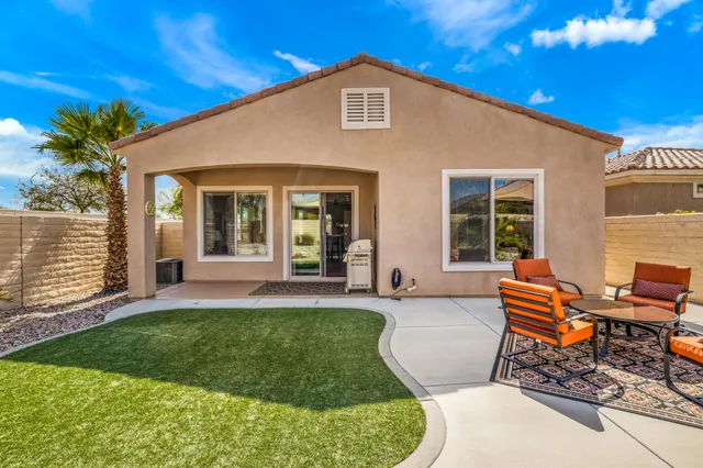 a front view of a house with a yard and outdoor seating