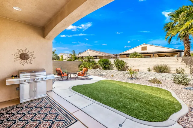 a view of a patio with a table and chairs