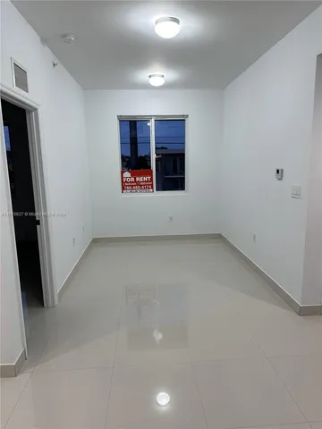 a white toilet sitting next to a shower