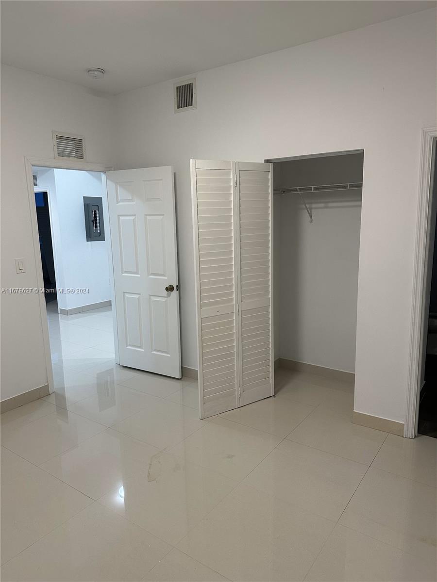 620 West 29th Street Hialeah, FL 33012 - Photo 19 of 26 an empty room with closet and mirror