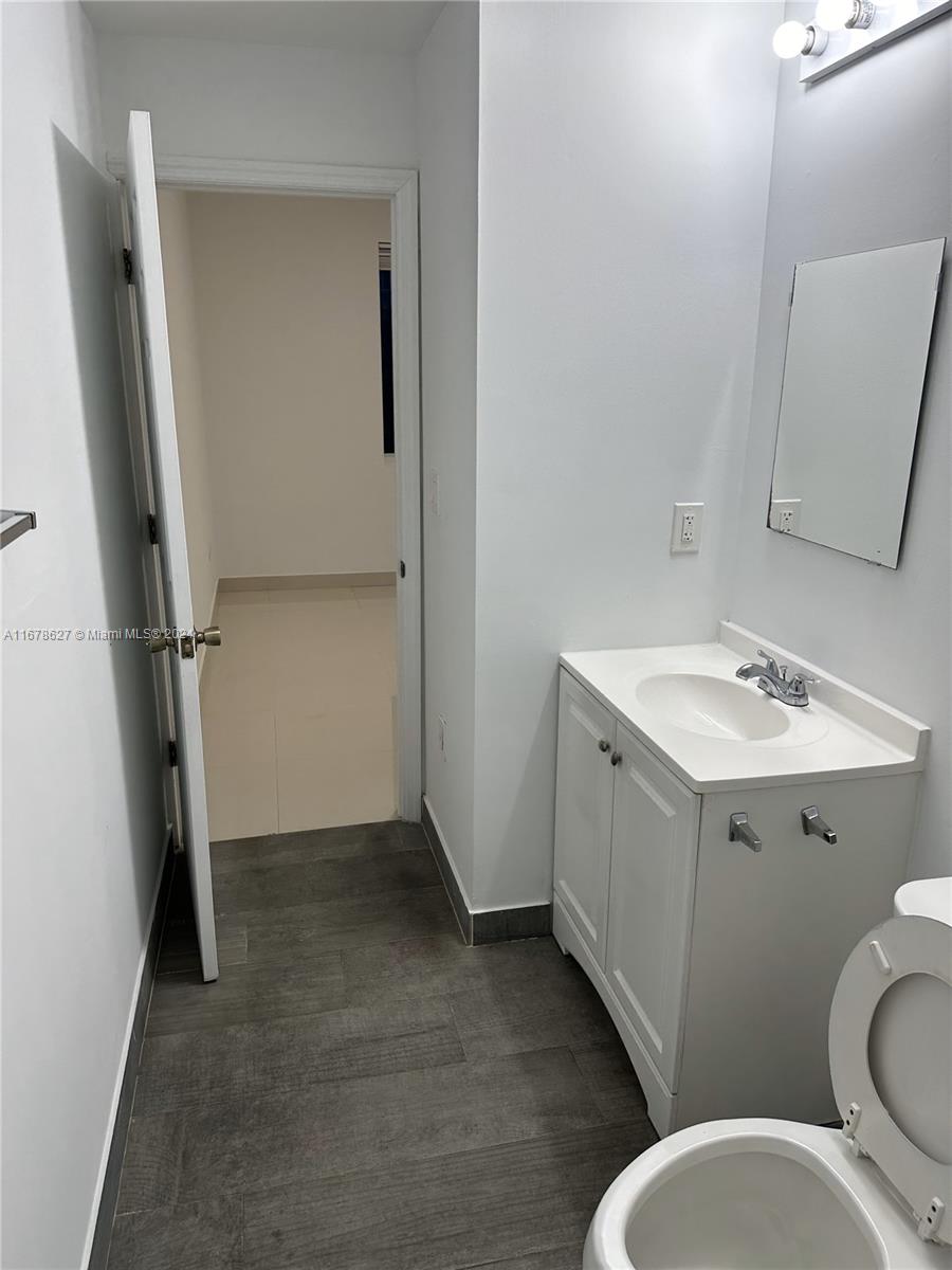 620 West 29th Street Hialeah, FL 33012 - Photo 21 of 26 a bathroom with a sink mirror vanity and toilet