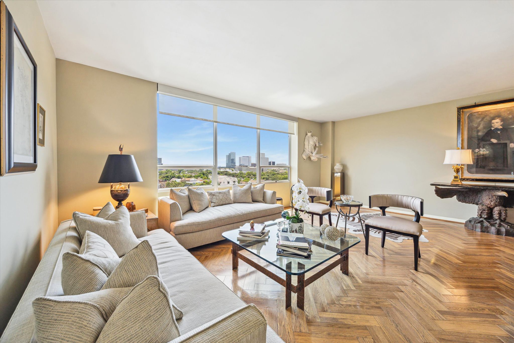Living area with gleaming herringbone wood floors.
