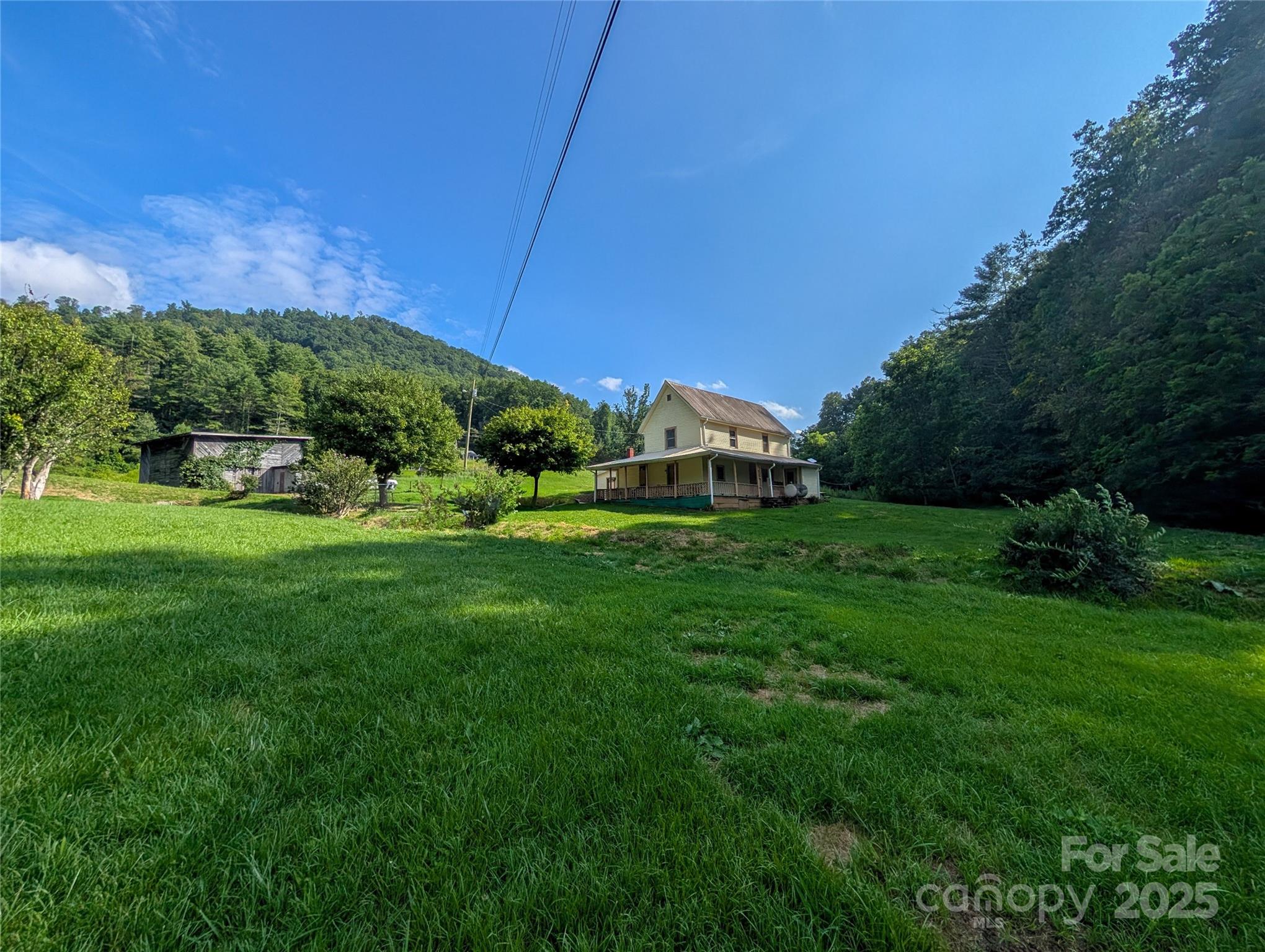 540 Pound Mill Branch Road Burnsville, NC 28714 - Photo 11 of 43 a front view of a house with garden