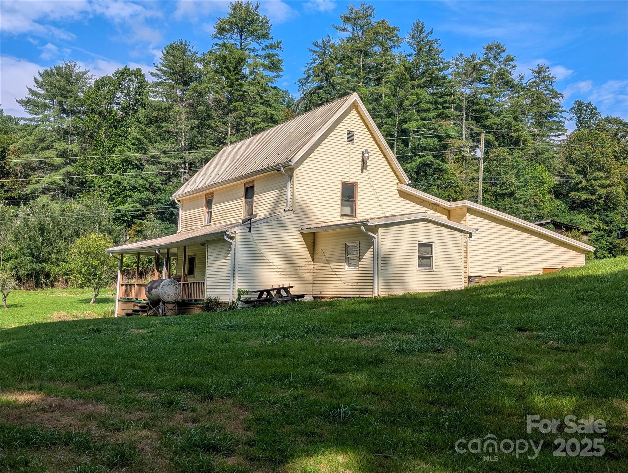 540 Pound Mill Branch Road Burnsville, NC 28714 - Photo 12 of 43 a view of a house with a yard