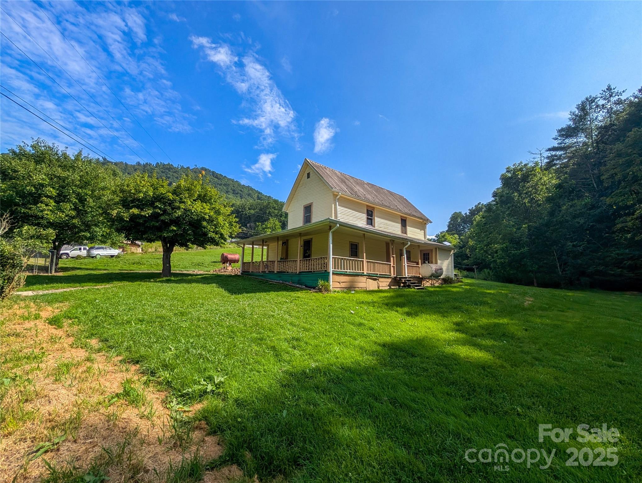 540 Pound Mill Branch Road Burnsville, NC 28714 - Photo 2 of 43 a front view of a house with a yard