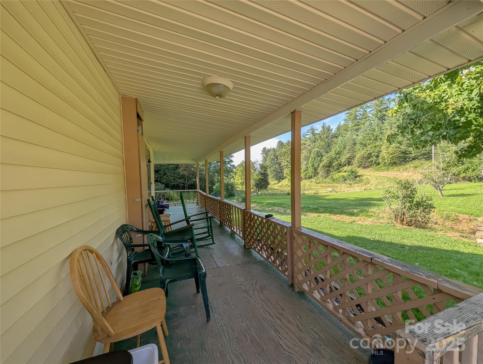 540 Pound Mill Branch Road Burnsville, NC 28714 - Photo 22 of 43 a view of a chairs and table in patio with wooden fence