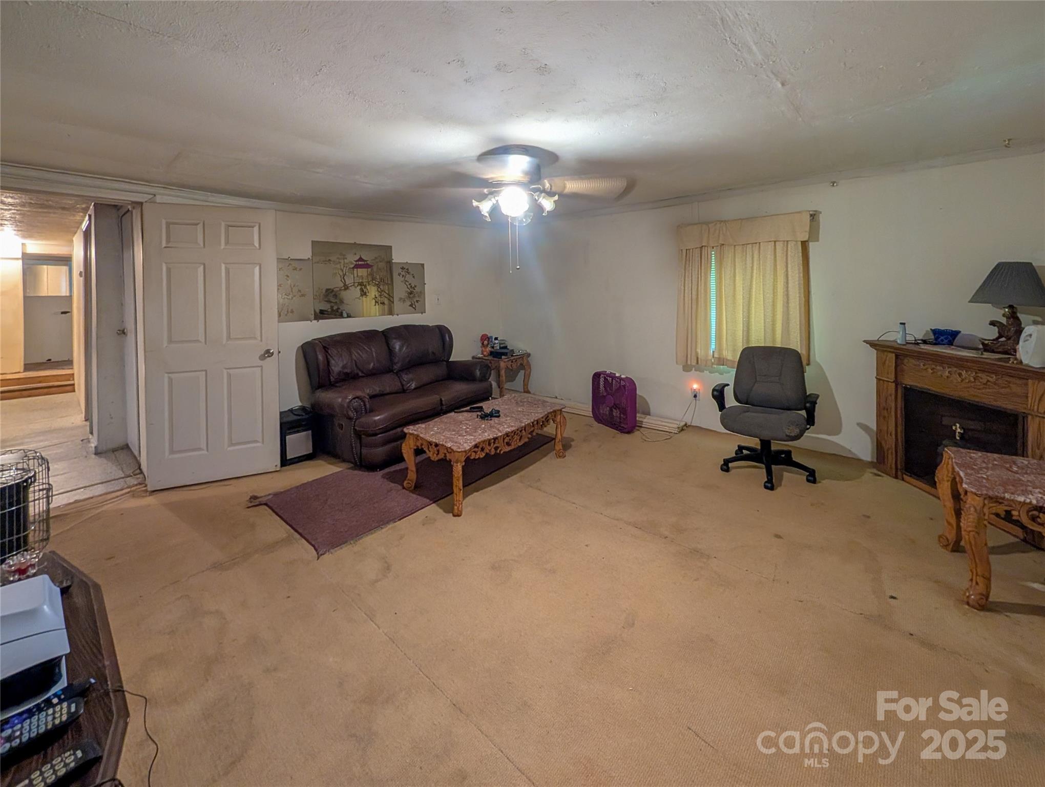 540 Pound Mill Branch Road Burnsville, NC 28714 - Photo 25 of 43 a bedroom with furniture and a window