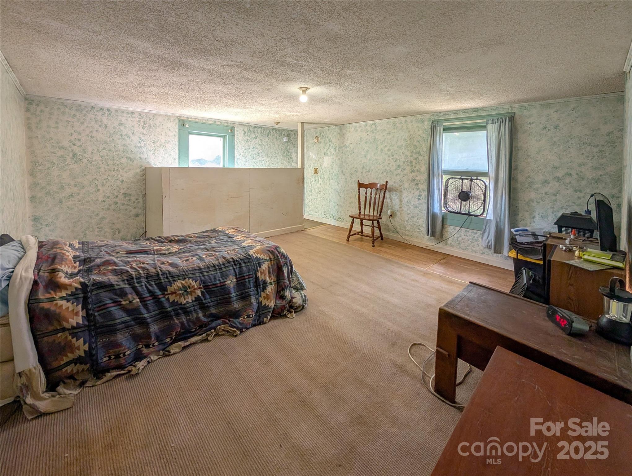 540 Pound Mill Branch Road Burnsville, NC 28714 - Photo 39 of 43 a bedroom with a bed and a dresser in it