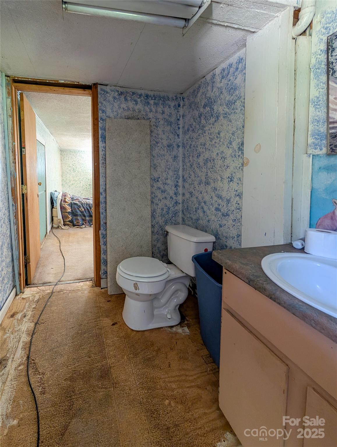 540 Pound Mill Branch Road Burnsville, NC 28714 - Photo 42 of 43 a bathroom with a granite countertop sink toilet and shower