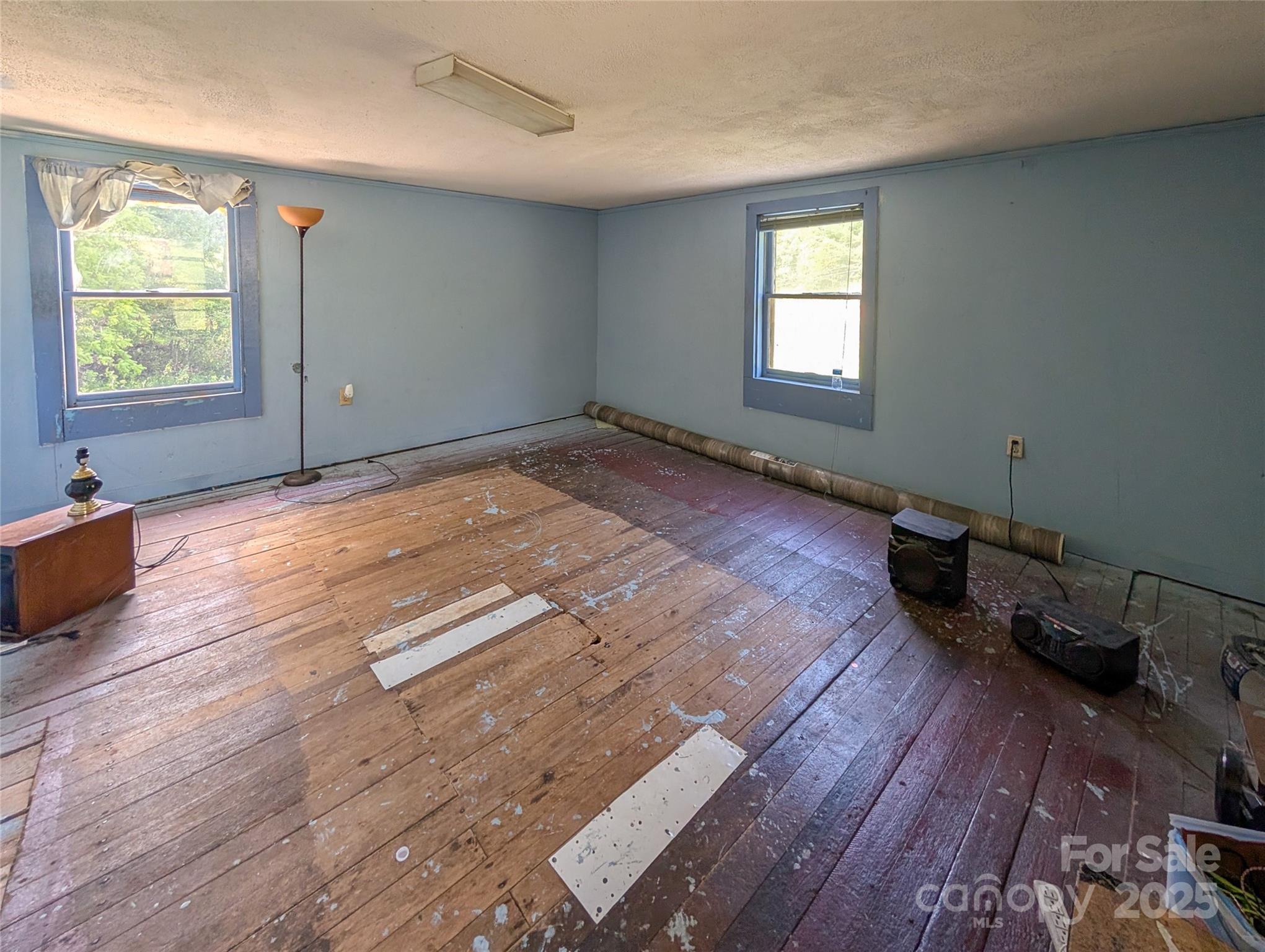 540 Pound Mill Branch Road Burnsville, NC 28714 - Photo 43 of 43 an empty room with wooden floor and windows