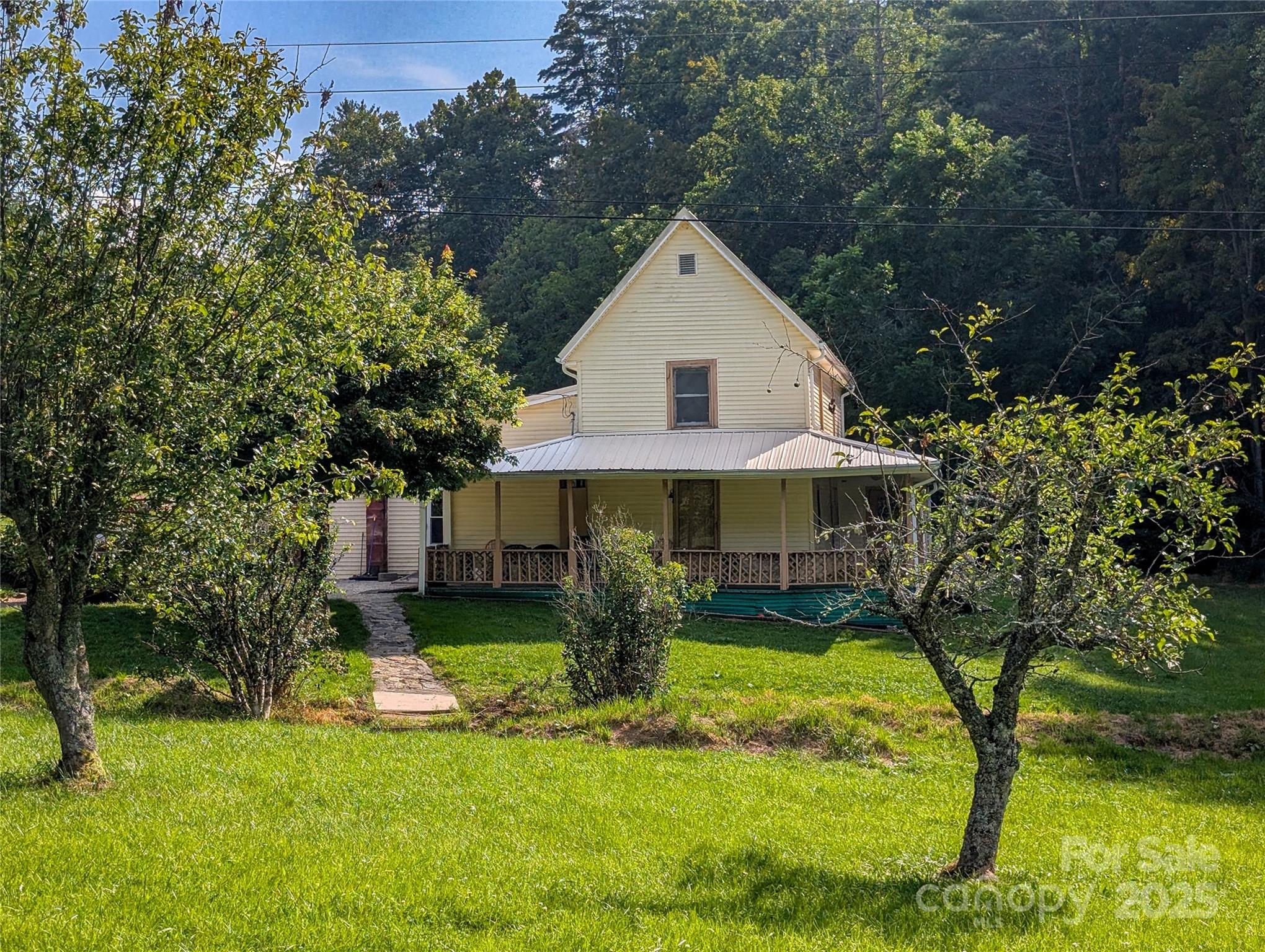 540 Pound Mill Branch Road Burnsville, NC 28714 - Photo 8 of 43 a view of a house with a yard garage and sitting area