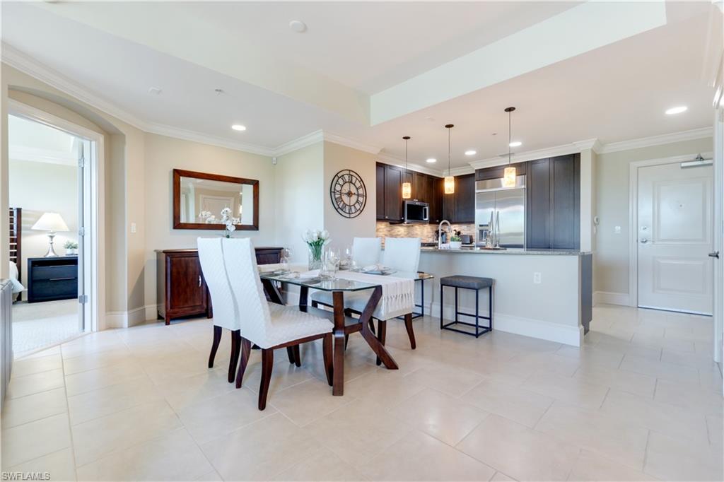 9115 Strada Place, Unit 5205 Naples, FL 34108 - Photo 1 of 36 a view of a dining room with furniture